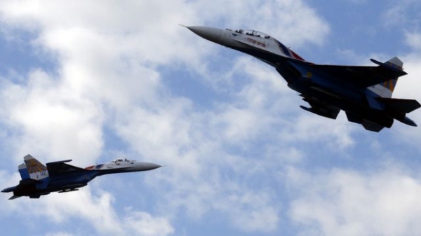 Two Russian SU-27s performing during the International Maritime Defence Show in Russia in 2015